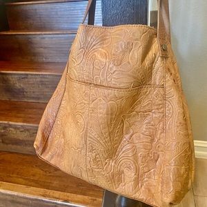 American leather. Soft leather. Very roomy.  Used. No stains smoke free.